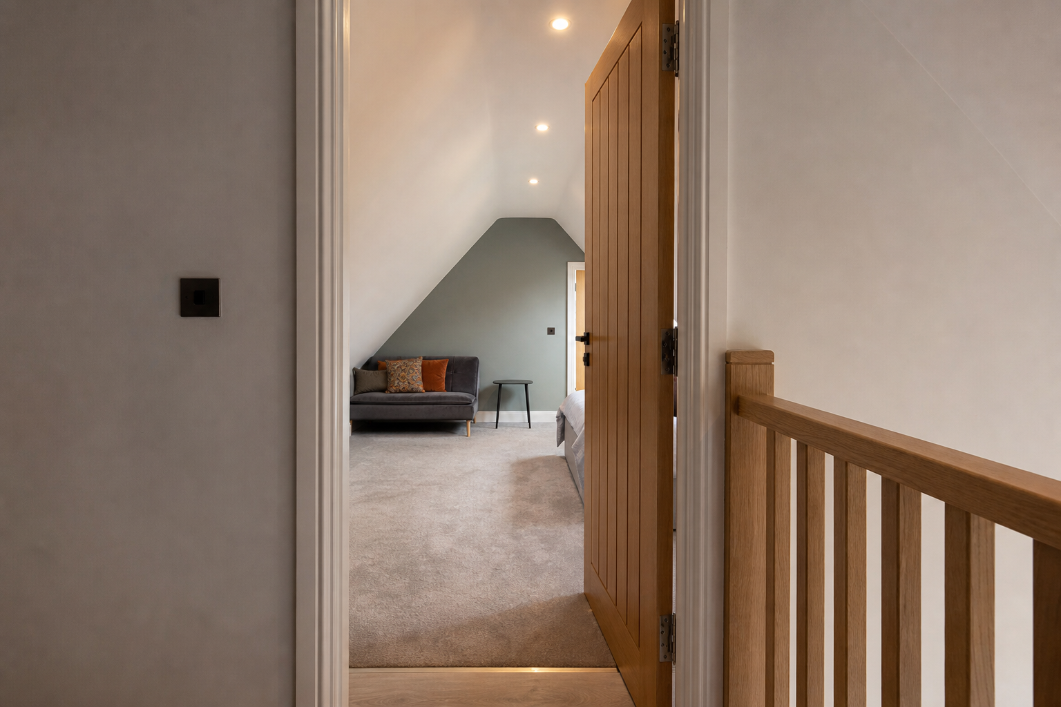 Loft staircase landing threshold with child-safe handrail detail