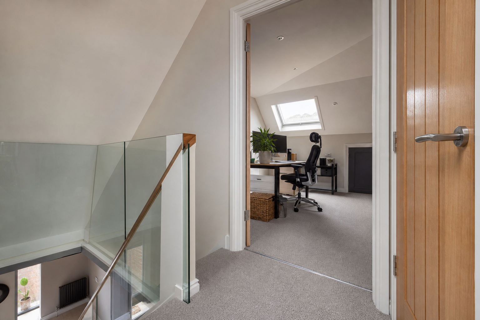 Solid-core door and landing threshold at the loft office entrance