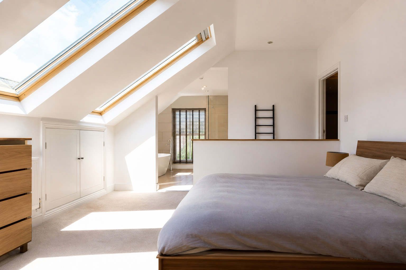 Multiple rooflights flooding the Hitchin loft bedroom with daylight