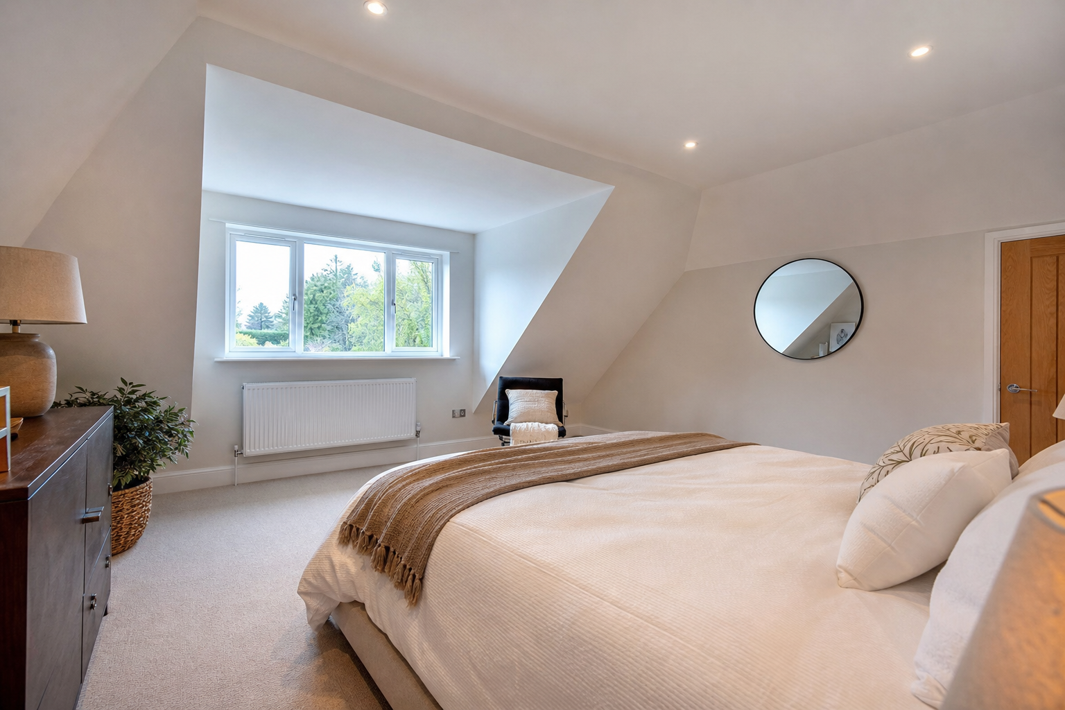 Interior view of the principal loft bedroom with garden-facing dormer