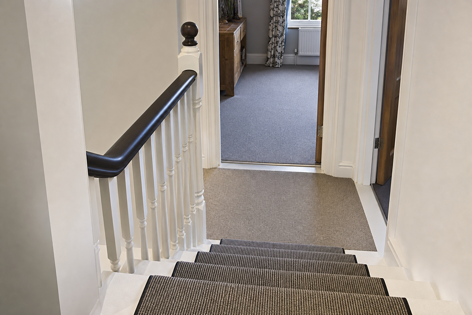 Loft staircase landing threshold with handrail at the new bedroom entrance